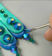 Clay peacock tail feathers with glass beads